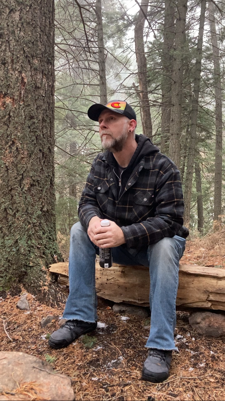 justin sitting in woods
